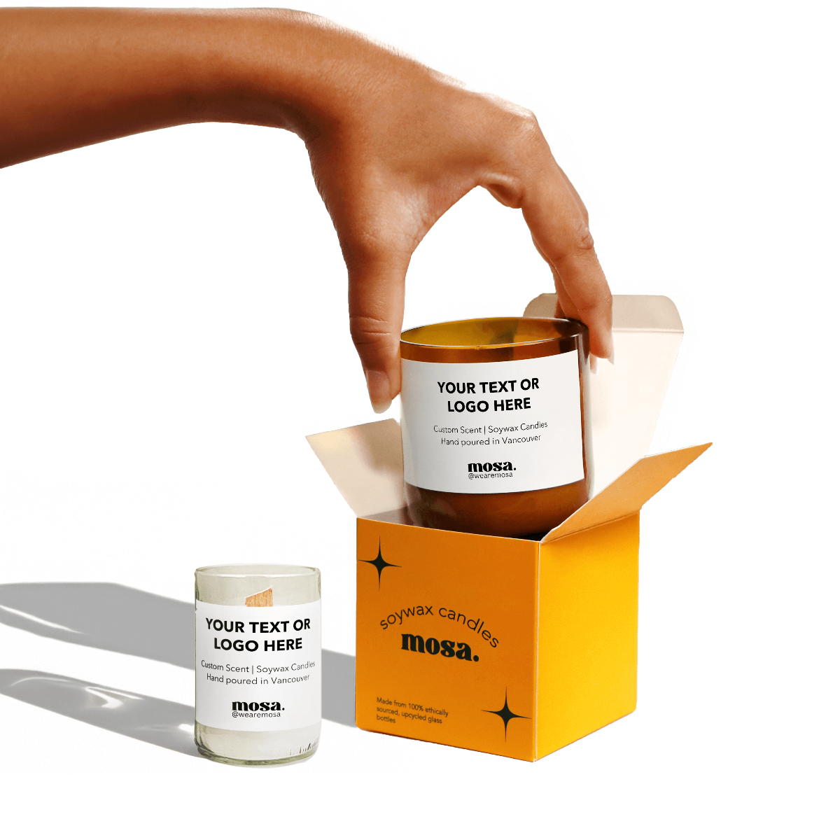 Hand holding a mosa candle with customizable text or logo on a white background