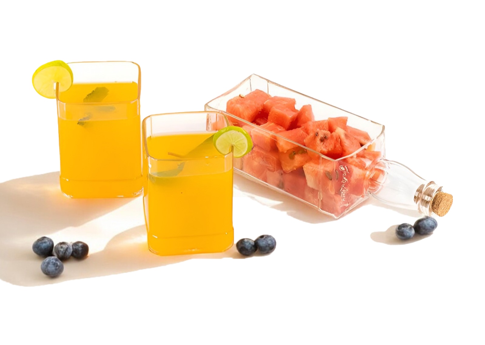 Two Jack Daneil Bottle Platter with glasses of orange juice with watermelon and blueberries on a white background