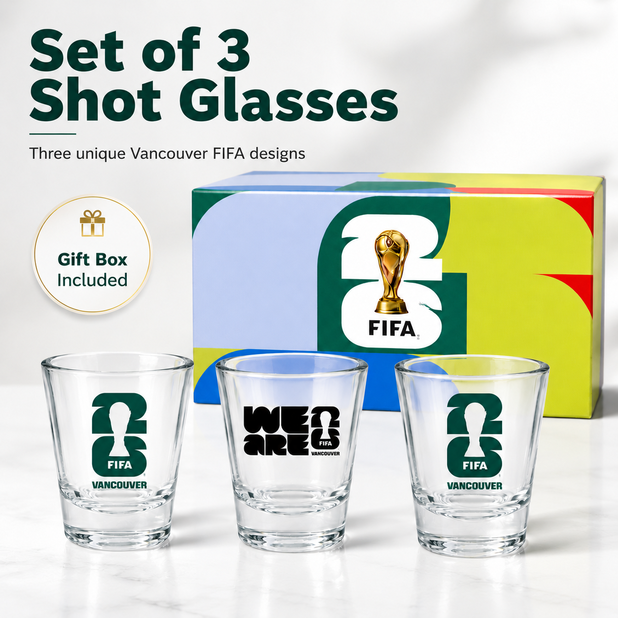Set of three shot glasses with FIFA designs and a gift box on a white background
