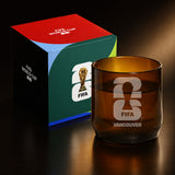Brown glass with FIFA Vancouver logo next to a colorful box with FIFA World Cup branding.