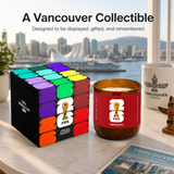Candle with FIFA Vancouver branding on a table with cityscape background