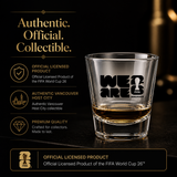 Clear shot glass with FIFA branding on a dark background