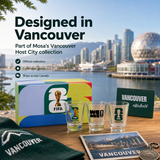 Collection of Vancouver-themed items including shot glasses, a box, and a card with city skyline in the background.