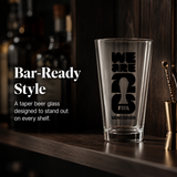 Empty beer glass with FIFA Vancouver design on a bar shelf