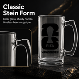 Empty glass beer mug with handle, featuring FIFA Vancouver logo, on dark background.
