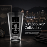 Empty glass with black text on a dark surface with Vancouver cityscape in the background