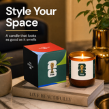 FIFA World Cup candle with packaging on a book, surrounded by plants and decor.