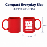 Red mug with 'WE ARE 26 VANCOUVER' text and measurements on a white background