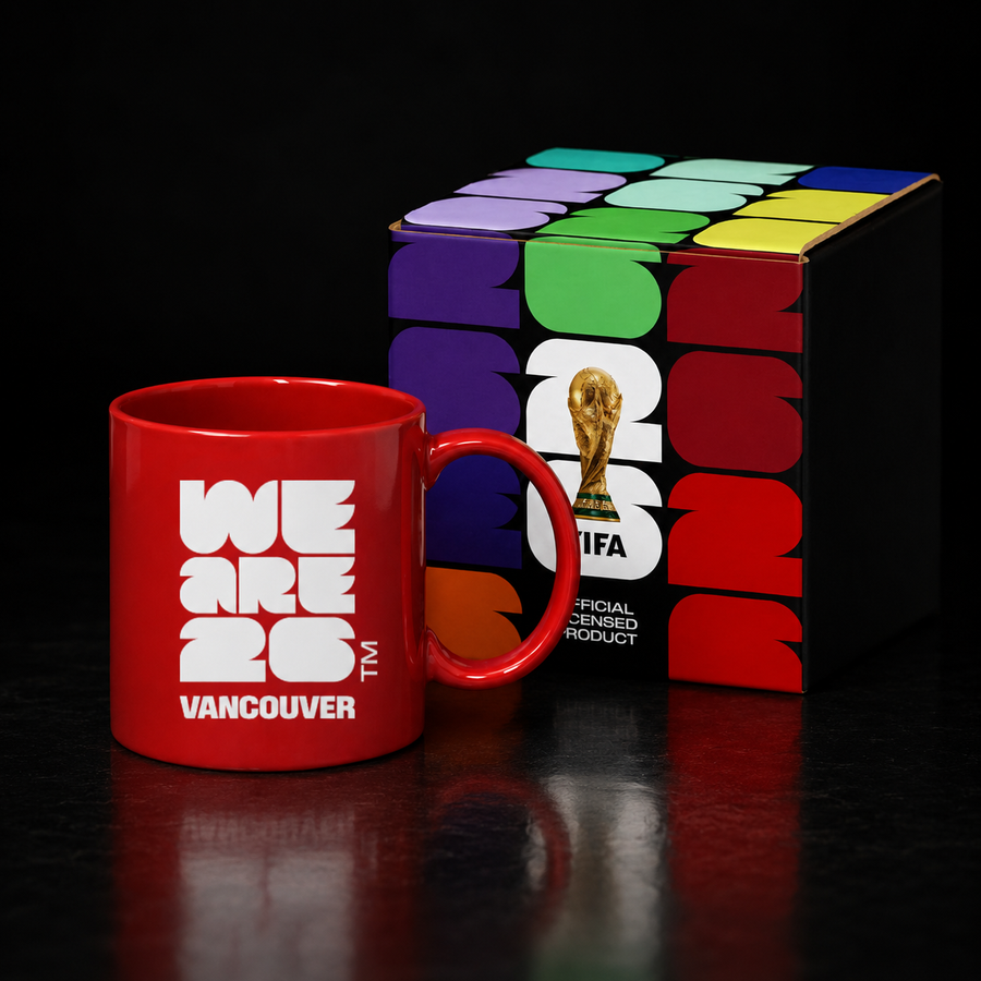 Red mug with 'WE ARE 26 VANCOUVER' text next to a Box with FIFA World Cup logo.